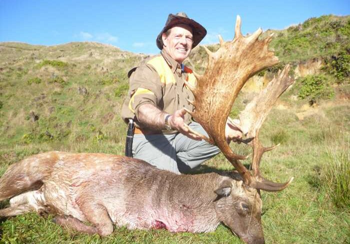 Matt Hall posing with dead buck